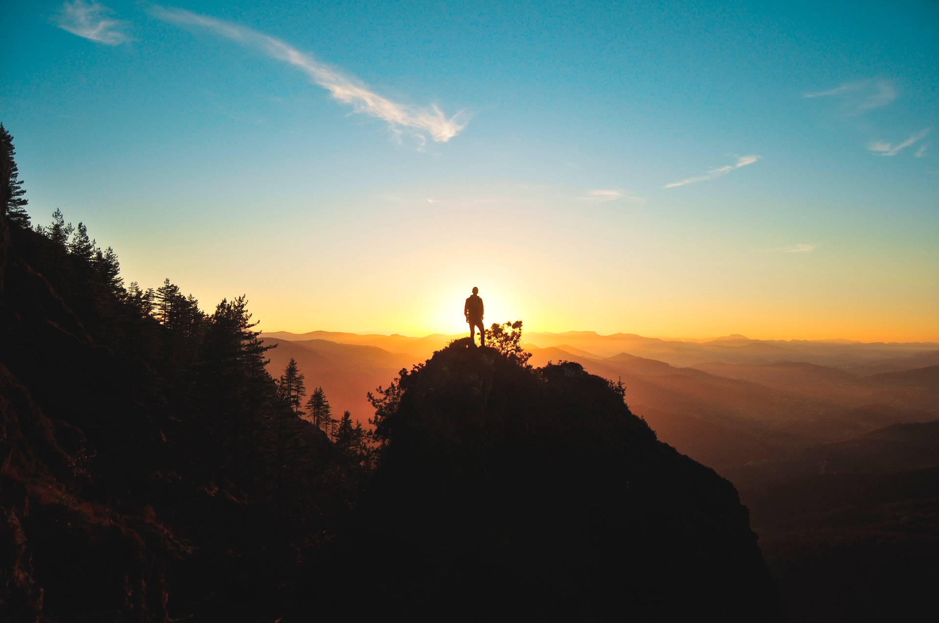 man facing sunset